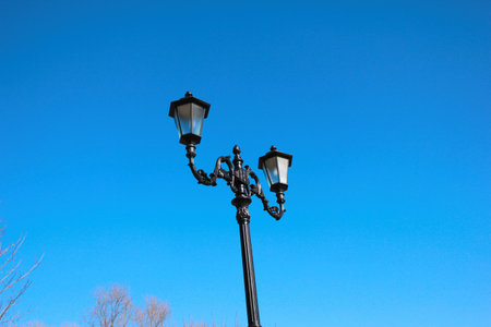 Ancient lantern on blue sky background, modern styling, black cast ironの写真素材