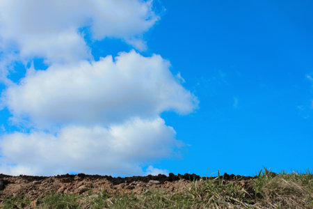 Soil fertility on the background of blue sky with cloudsの写真素材