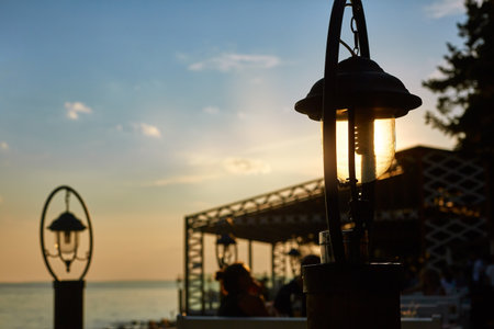 lanterns in the sun on the beach at sunsetの写真素材