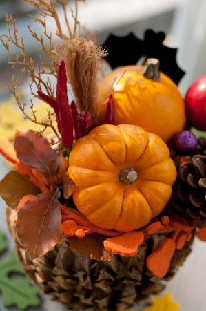 Pumpkins, gold autumn leaves pine cones. Image of Halloween season