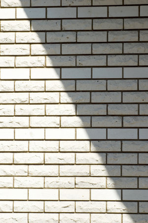 White brick wall with a shadow, backgroundの写真素材