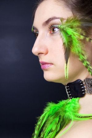 Portrait beautiful woman with long hair and feathers, verticalの写真素材