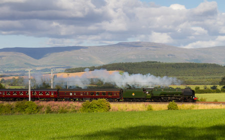 The Cumbrian Mountain Express.  Preserved steam locomotive Duchess of Sutherland is pictured in Clifton, England hauling the Cumbrian Mountain Express.のeditorial素材