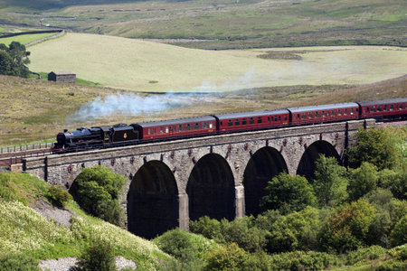 The Waverley.  Preserved steam locomotive 45407 heads the Waverley over Dent Head Viaduct, on the Settle to Carlisle railway.のeditorial素材
