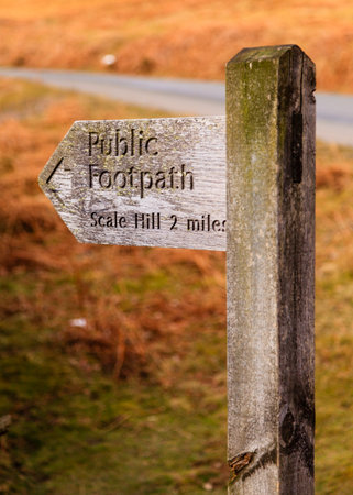 Public Footpath Sign.  A wooden signpost marking a public footpath close to Crummock Water in the English Lake District national park.の写真素材