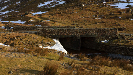 Stone Bridge.  A stone bridge crossing Gatesgarthdale Beck at Moss Crag in the English Lake District national park.の写真素材