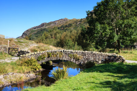 Stone Packhorse Bridge. The stone packhorse bridge crossing Watendlath Beck is situated in Watendlath, Cumbria above Derwentwater in the English Lake District national park.の写真素材