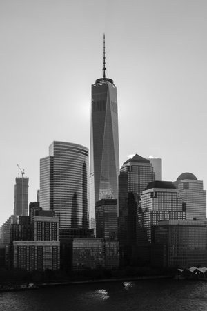 A black and white image of the Lower Manhattan skyline in New York City.  The One World Trade Centre...