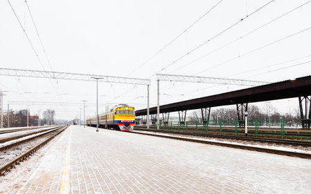 The view along a frosty platform at Riga Central Station as a train arrives.  The station is in the capital city of Latvia.のeditorial素材