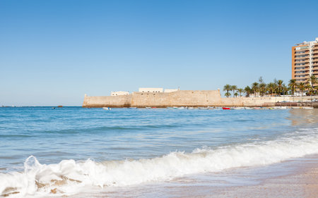 The view across La Caleta beach towards the castle of Santa Catalina in Cadiz, Spain.のeditorial素材