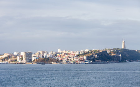 The view across the Tagus River towards the city of Almada, Portugal.  In the background can be seen the Christ the King Sanctuary.の写真素材