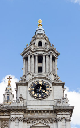 A close up picture of the clock tower of Saint Paul's cathedral.  The cathedral is an Anglican...