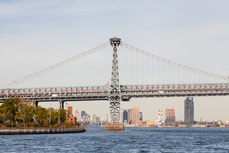 A view of Williamsburg Bridge in New York City.  The bridge spans the East River connecting the...