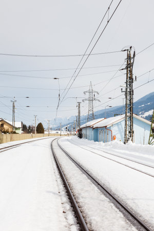 The view along a snow covered railway track from Bruck - Fusch Station in the state of Salzburg, Austria.  Bruck and Fusch are both municipalities in Zell am See district.の写真素材