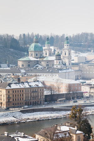 A winter view across the Salzach river from Kapuzinerberg mountain in Austria.  Salzburg Cathedral in the "Old" town can be seen.のeditorial素材