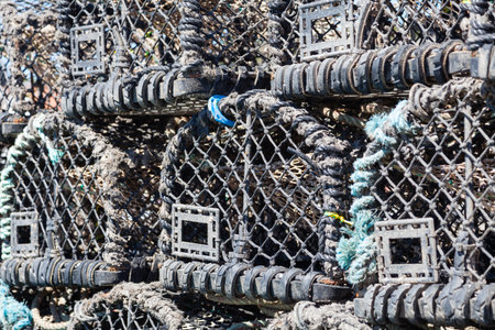 A close up of lobster fishing pots stacked on the keyside of the seaside town of Whitby in...