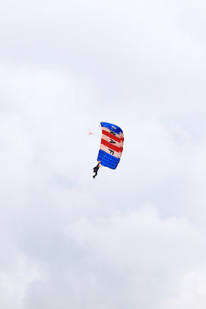 A parachutist from the RAF Falcons Parachute Display Team performs in the skies above Silverstone, England.のeditorial素材