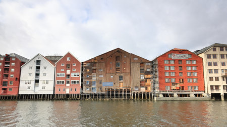 Old wooden storehouses beside the Nidelva River in Trondheim, Norway.のeditorial素材