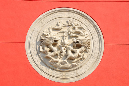 Chinese temple in Hongkong, white mortar dragon in red background の写真素材