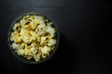 Caramel popcorn on dark background with hard light, modern luxury conceptの写真素材