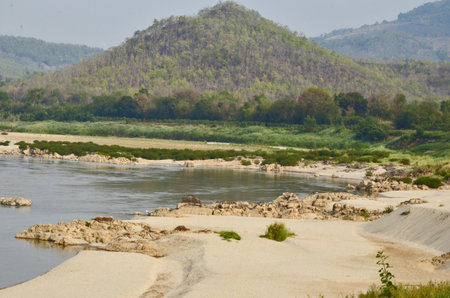 Sand beach of Khong river near mountainの写真素材
