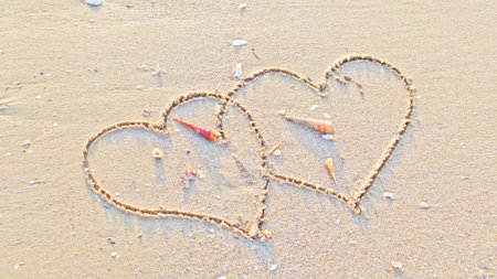 Couple hearts on the sandの写真素材