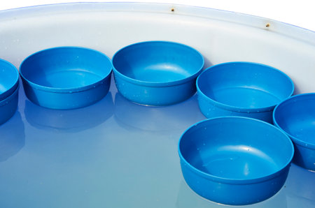Blue bowls in the water barrelの写真素材