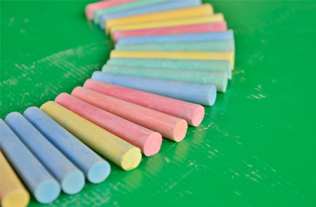 Pieces of chalk on plastic board