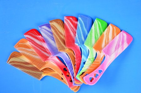 Color plastic combs on blue backgroundの写真素材