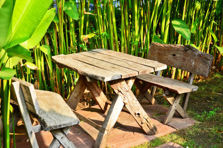 Wood table with chairs in the gardenの写真素材