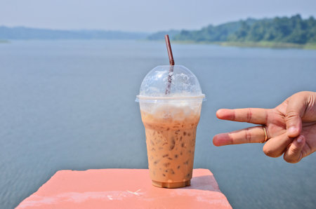 Cool coffee cup with victory fingersの写真素材