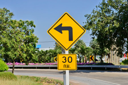 Turn left with limited speed signの写真素材