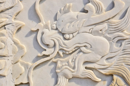 Low relief dragon on white marbleの写真素材