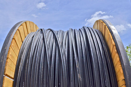 Electric cable reel with blue skyの写真素材