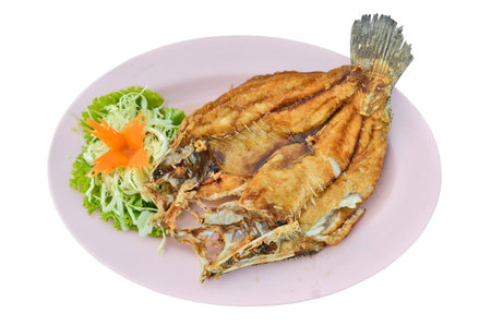 Fried widespread snapper with fresh vegetableの写真素材