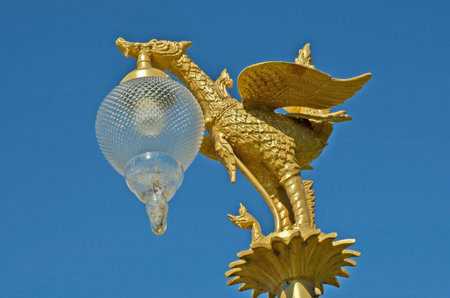 Golden swan sculpture with light lampの写真素材