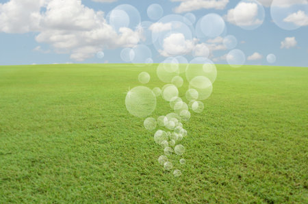 Floating air bubbles over green fieldの写真素材