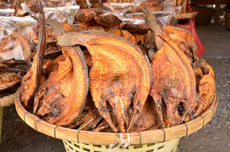 Dried grilled fish in basket for saleの写真素材