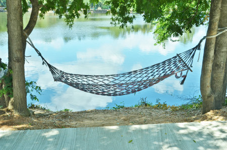 The hammock beside clear waterの写真素材