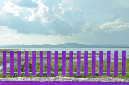 Violet fence with beautiful water under blue skyの写真素材