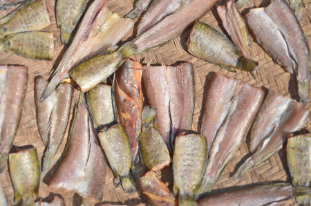 Drying spread fish on woven basket