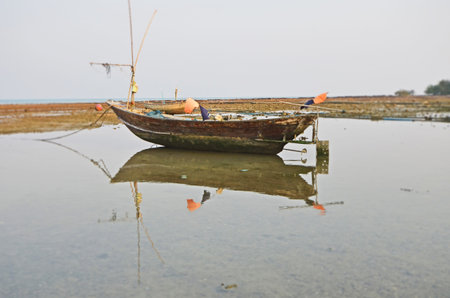 Old fisherman boat and the reflection shadow