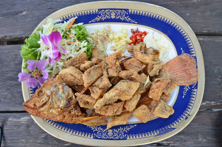 Fried pieces of fish with body and herbsの写真素材