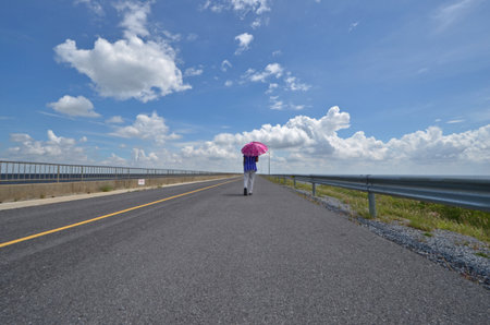 Long black road under beautiful skyの写真素材