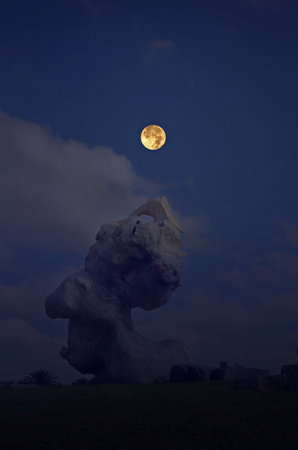 Wonderful stone with full moon in the eveningの写真素材