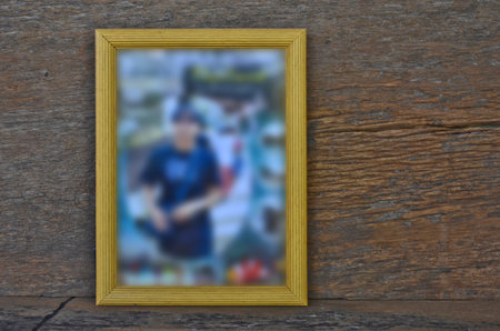 Blur picture in yellow frame on wood backgroundの写真素材