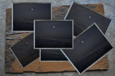 Old pictures with frames on wood floorの写真素材