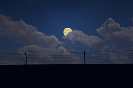 Full moon and white coulds over the wallの写真素材