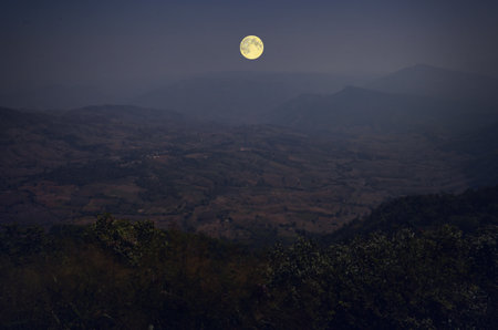 Full moon over the mountain in the eveningの写真素材