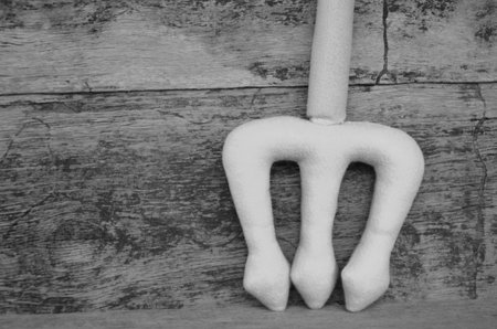 Black and white fork weapon on wood backgroundの写真素材